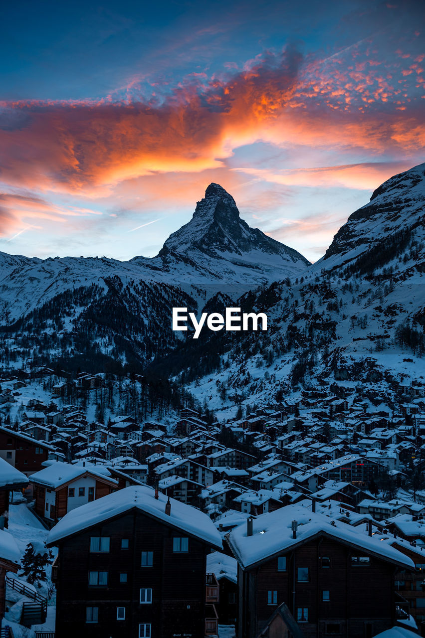 SNOWCAPPED MOUNTAIN AGAINST SKY DURING SUNSET