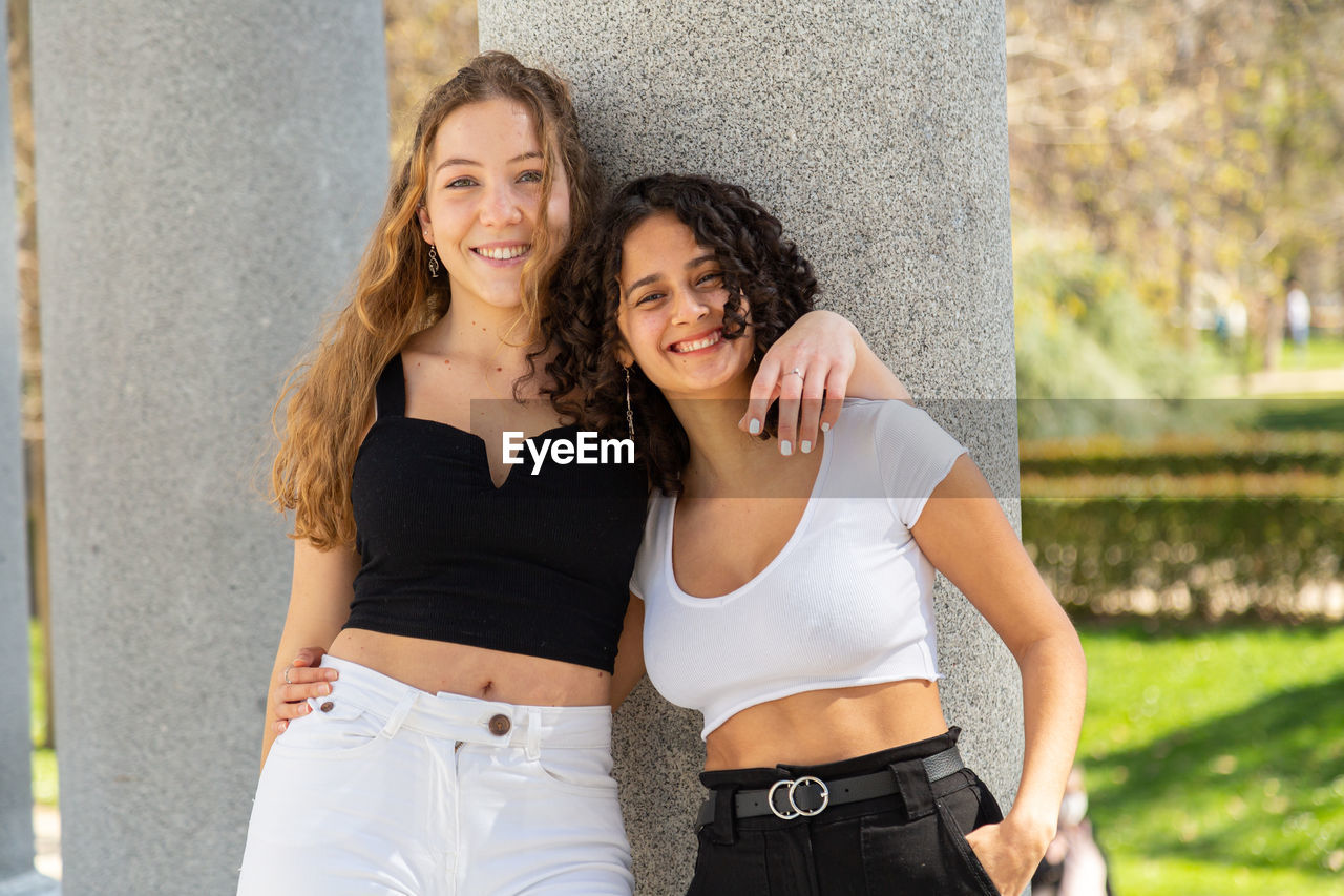 Young women friends enjoying in the city park