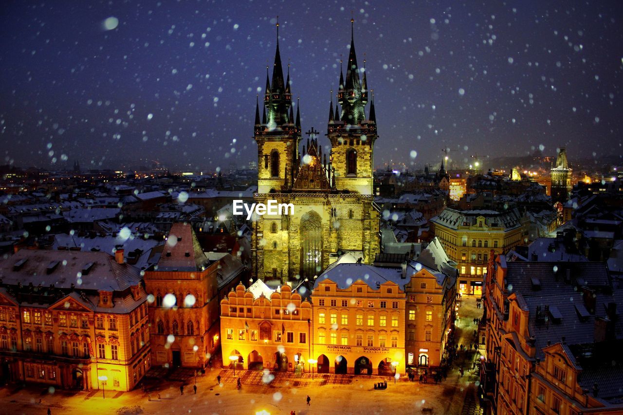 Illuminated church of our lady before tyn against sky during winter