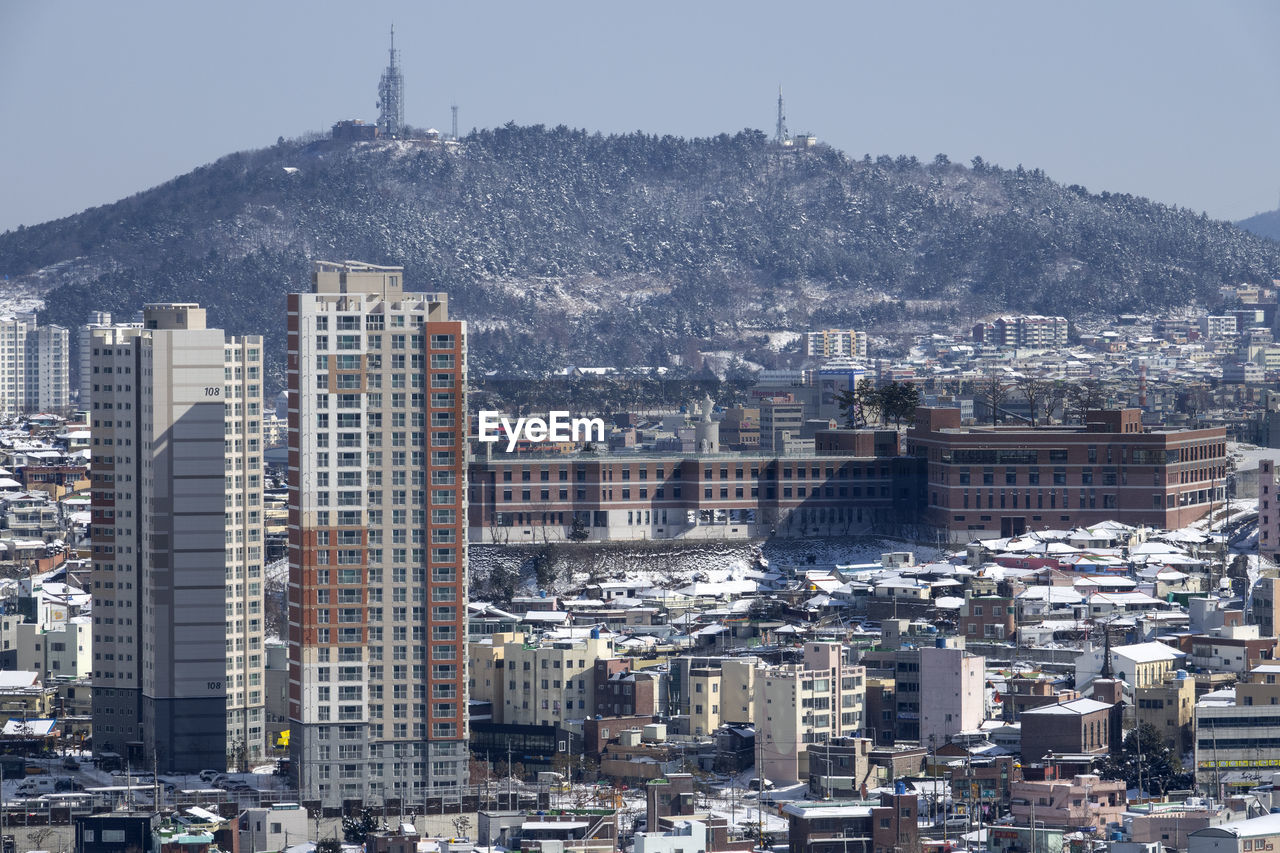 High angle view of buildings in city against clear sky