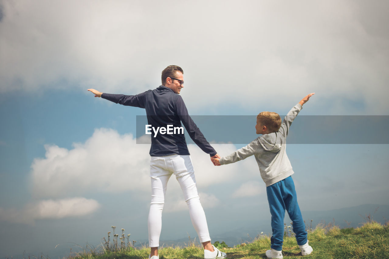 Father and son spending leisure time on mountain