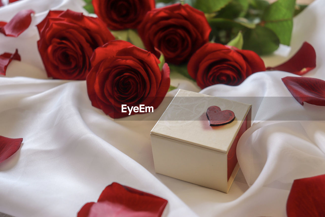 HIGH ANGLE VIEW OF ROSE BOUQUET ON WHITE ROSES