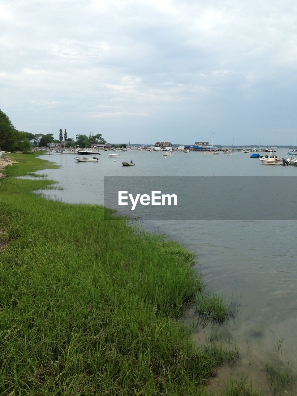 Boats moored in river against sky