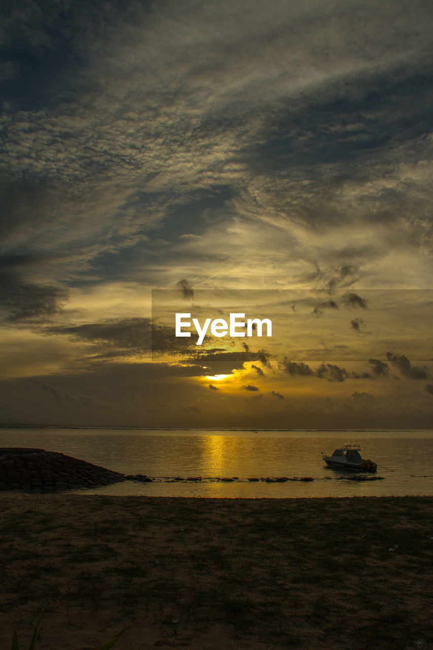 View of calm and scenic sea at sunset