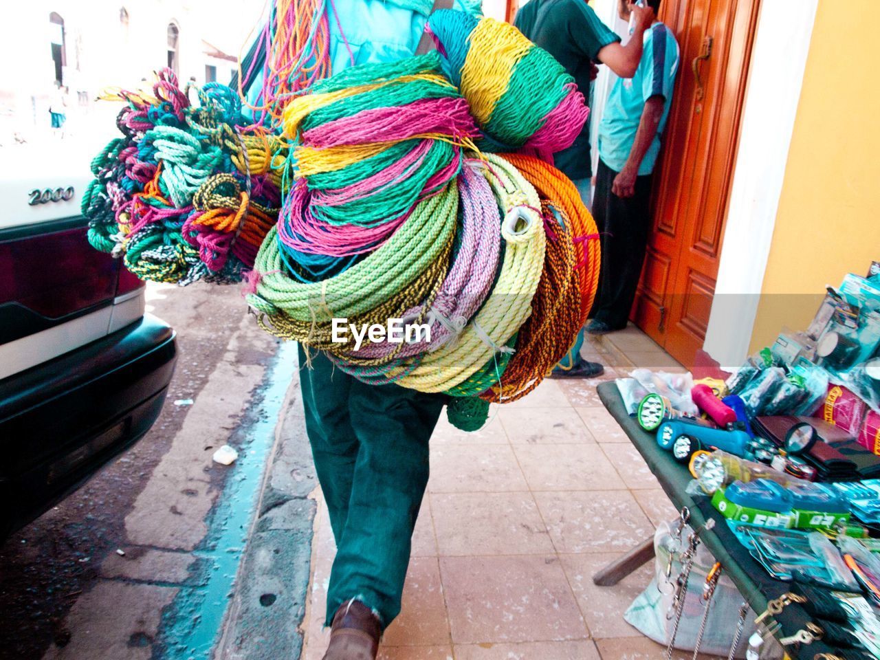 Person carrying multicolored wool