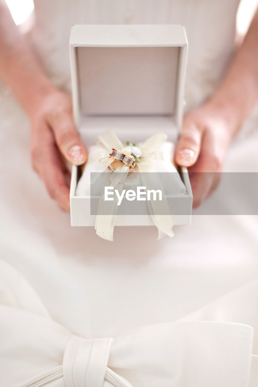 Midsection of woman holding wedding rings box