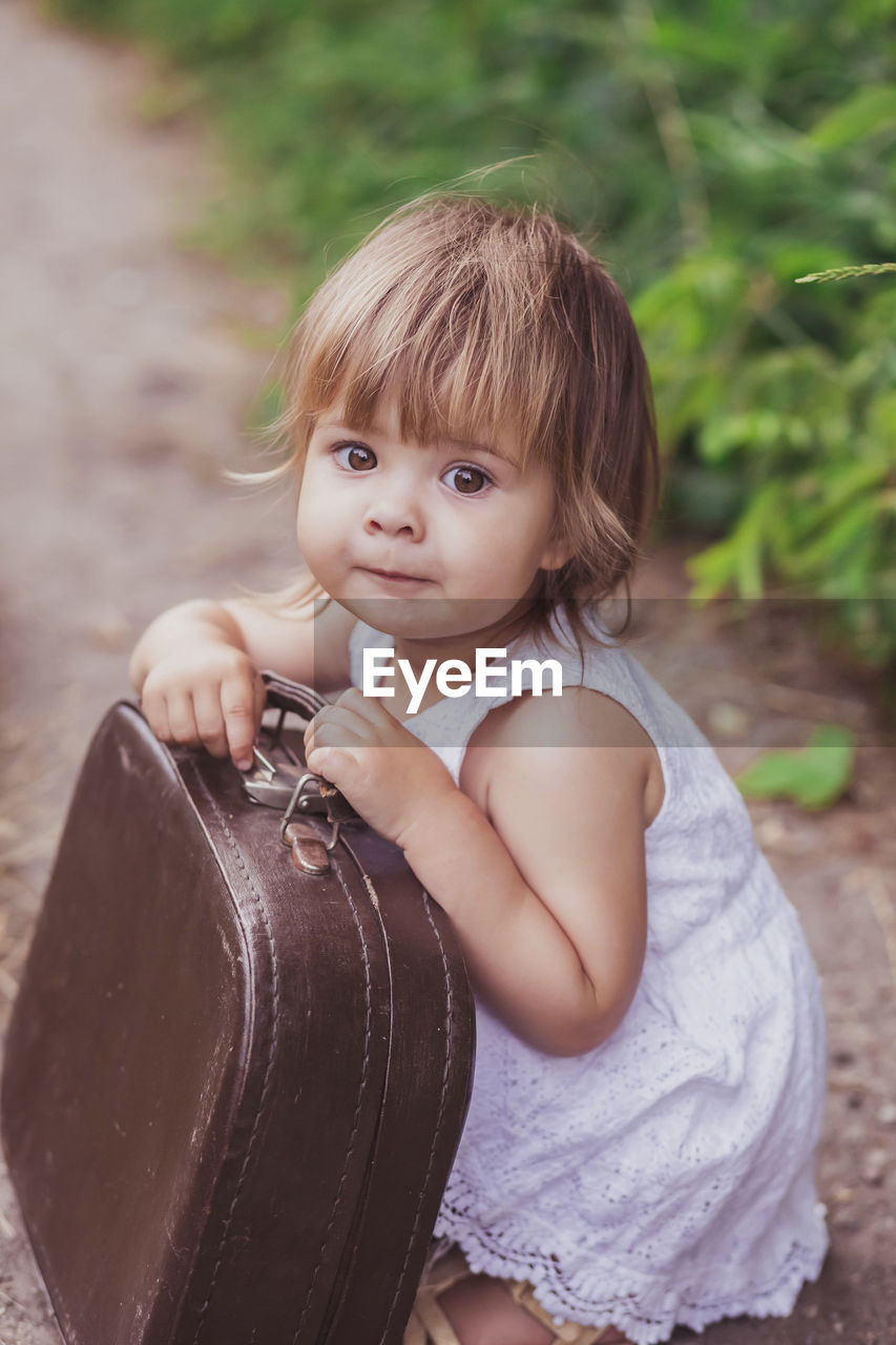 Adorable child with a suitcase