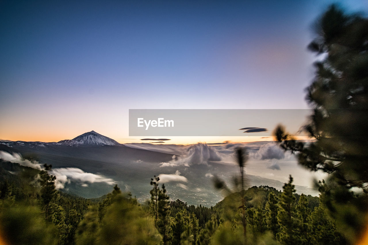 SCENIC VIEW OF MOUNTAINS AGAINST SKY AT SUNSET