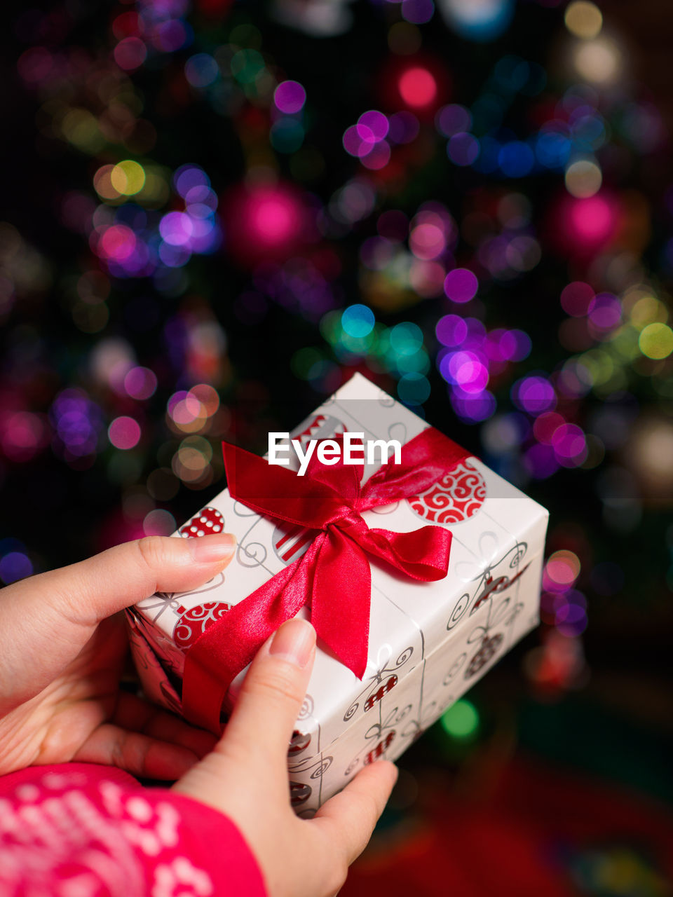 Cropped image of hands holding christmas present