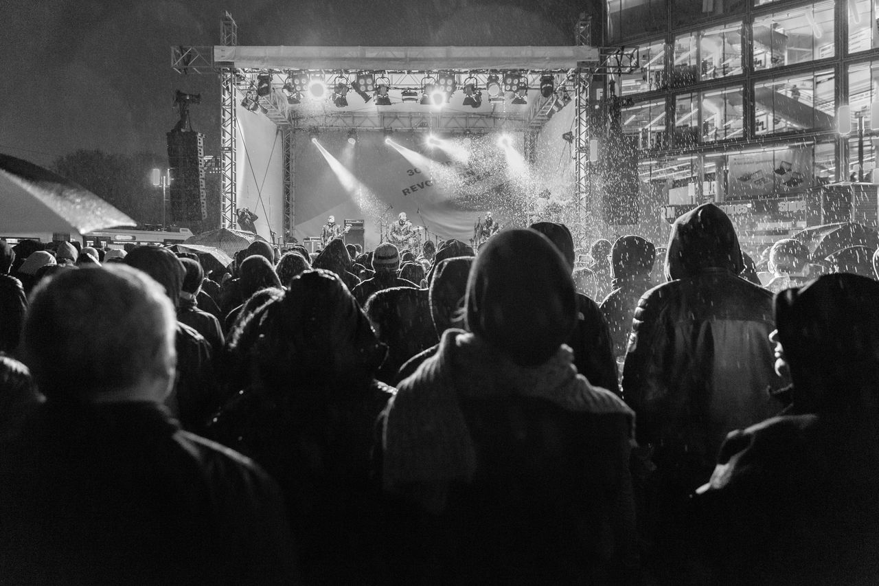 REAR VIEW OF PEOPLE WATCHING MUSIC CONCERT