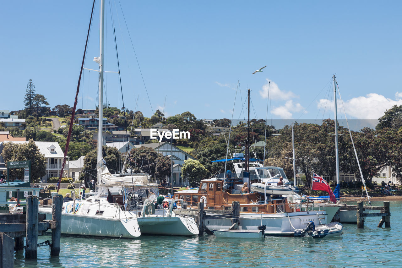 SAILBOATS MOORED IN SEA