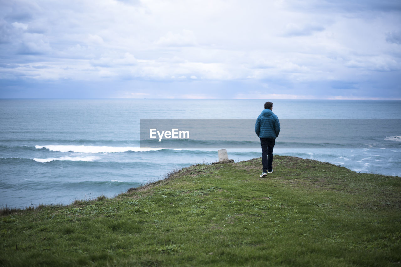 Man exploring the dusky coastline of spain