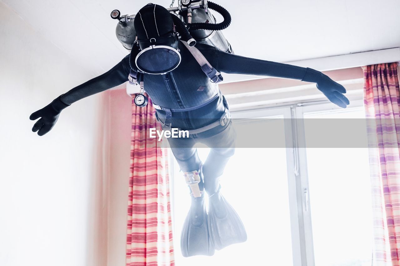 Low angle view of diving suit hanging at home