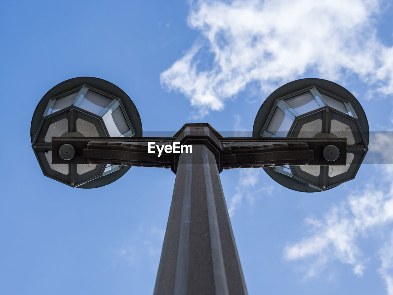 Low angle view of street lamp at karl marx allee against blue sky