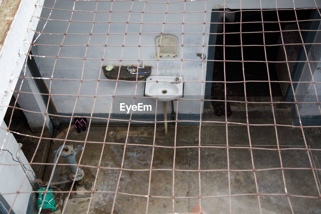 High angle view of metal grate over courtyard with sink