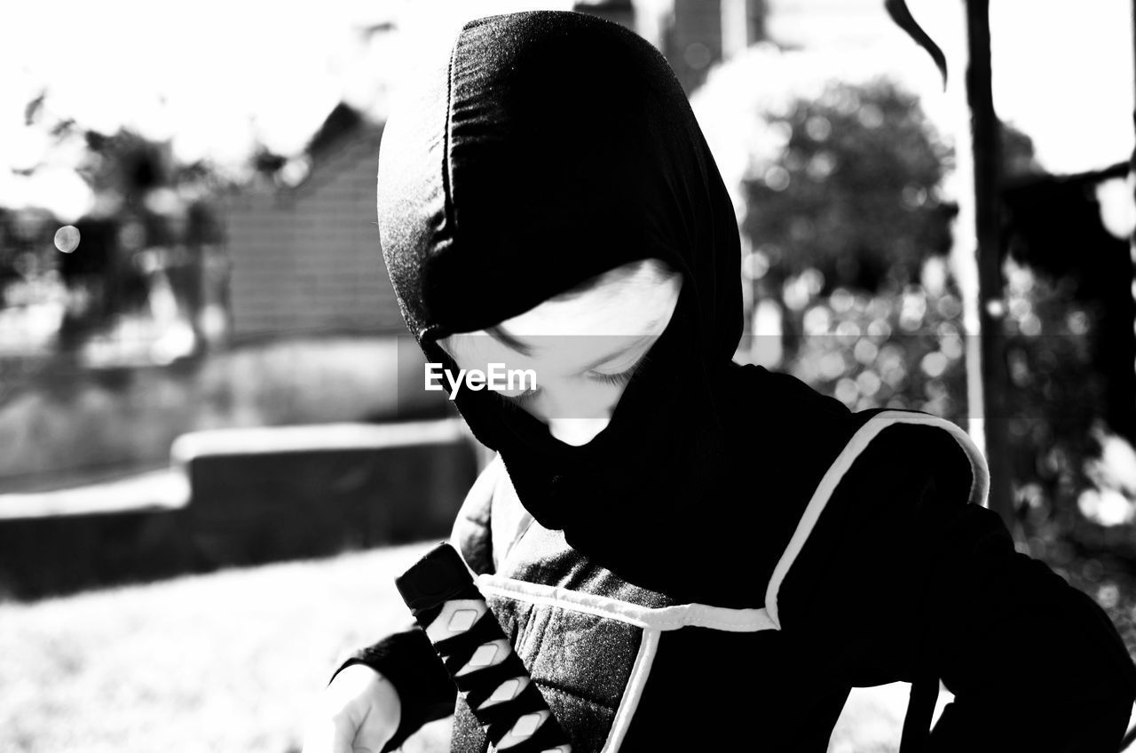 Boy wearing ninja costume while standing outdoors