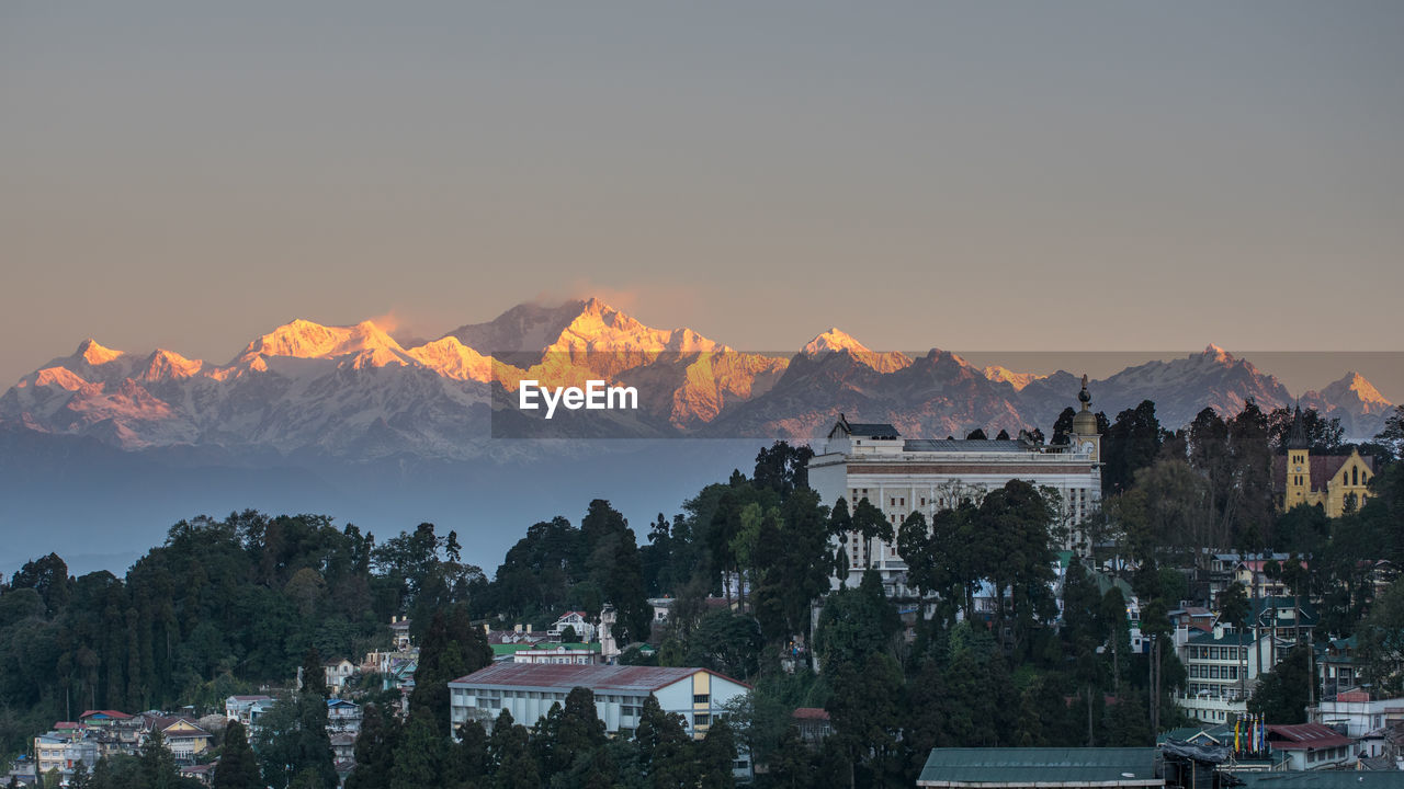 Panoramic shot of townscape against sky at sunset