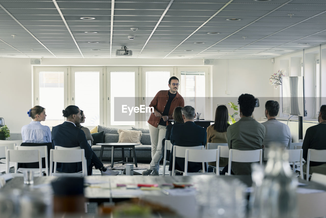 Group of business people attending presentation during conference