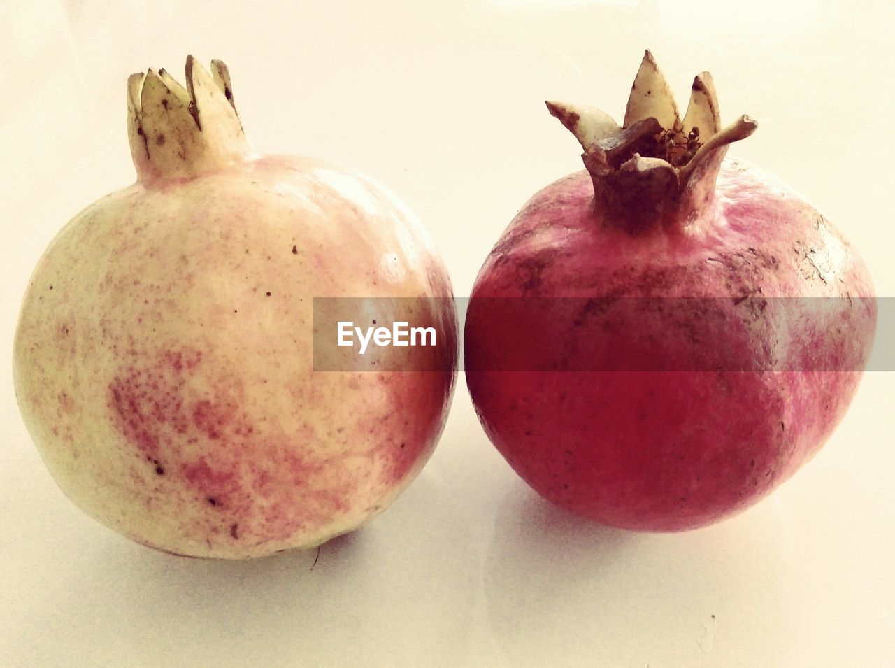 Close-up of pomegranates over white surface