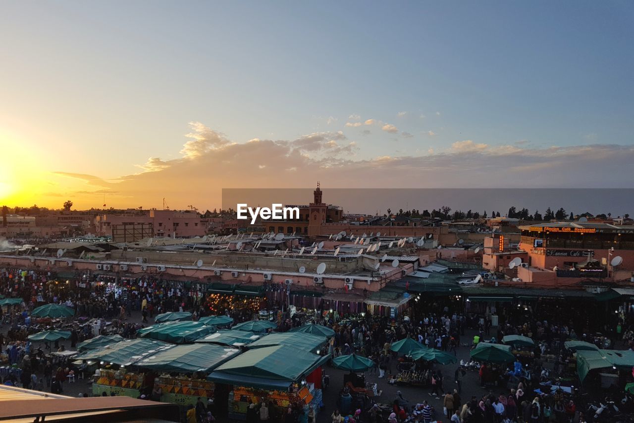 High angle view of buildings in city at sunset