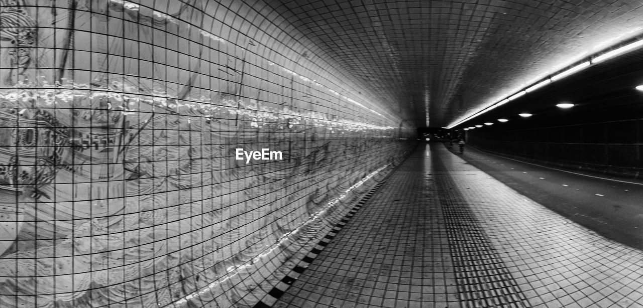 black and white, tunnel, monochrome, architecture, infrastructure, monochrome photography, line, indoors, the way forward, transportation, no people, built structure, pattern, diminishing perspective, illuminated, vanishing point, ceiling, public transportation, lighting equipment, black
