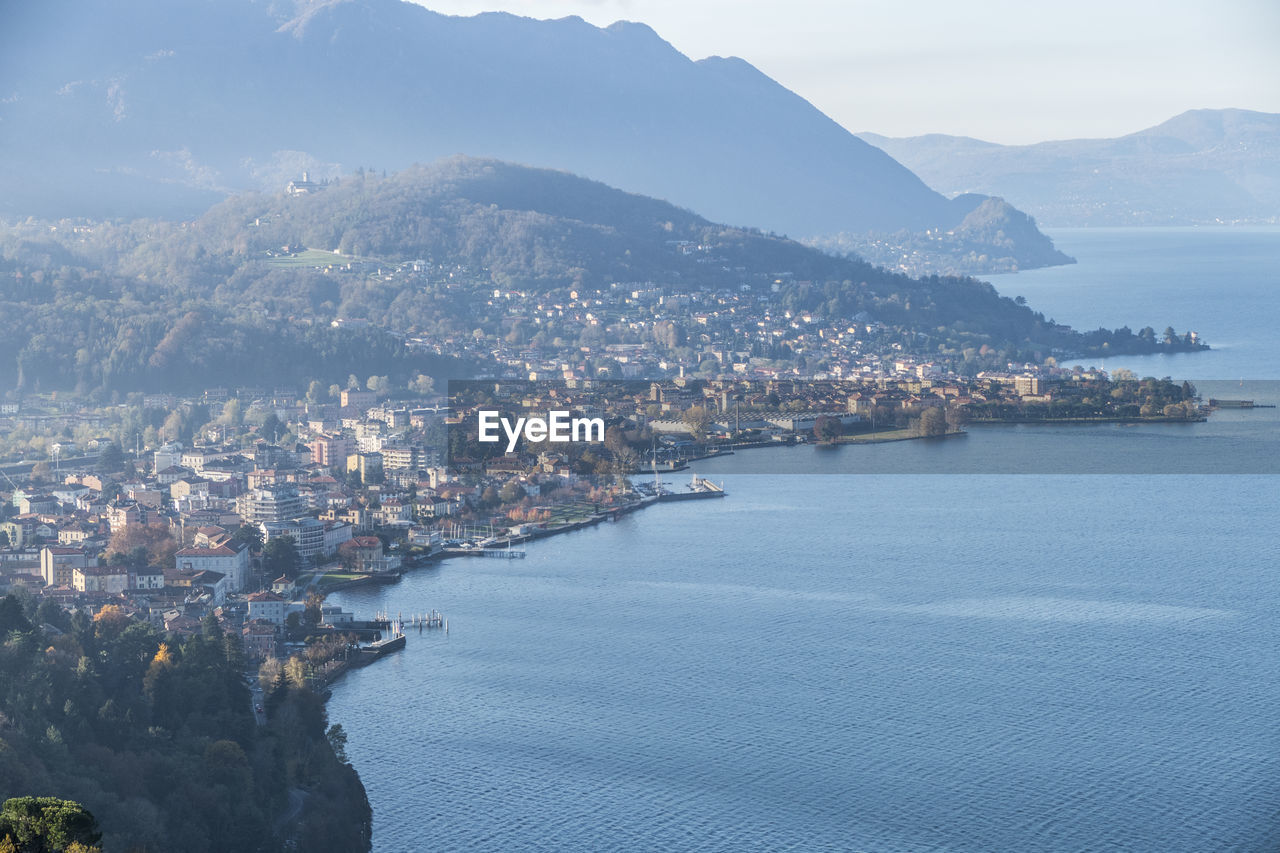 High angle view of city by sea against sky