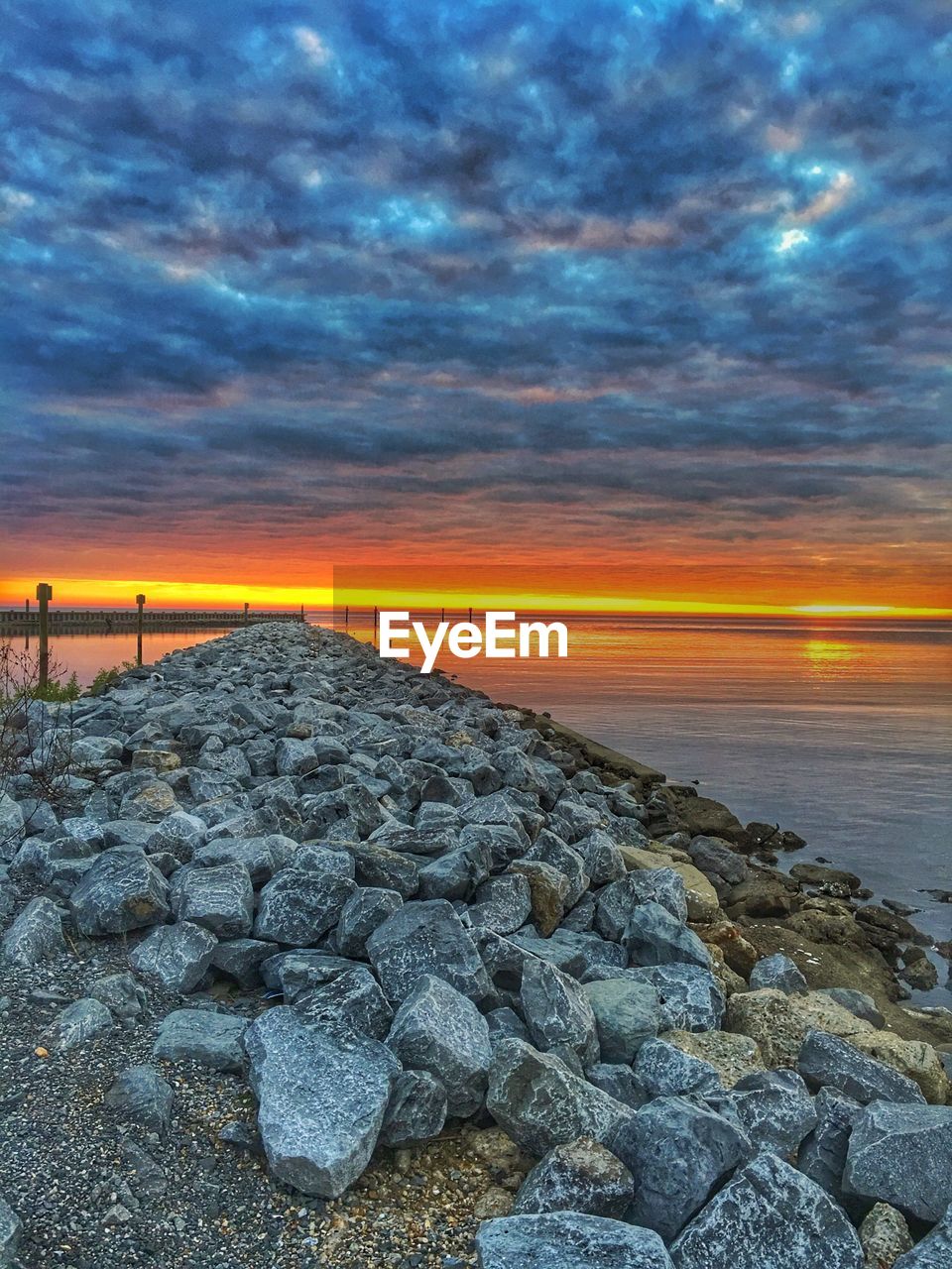 SCENIC VIEW OF BEACH AGAINST SKY DURING SUNSET