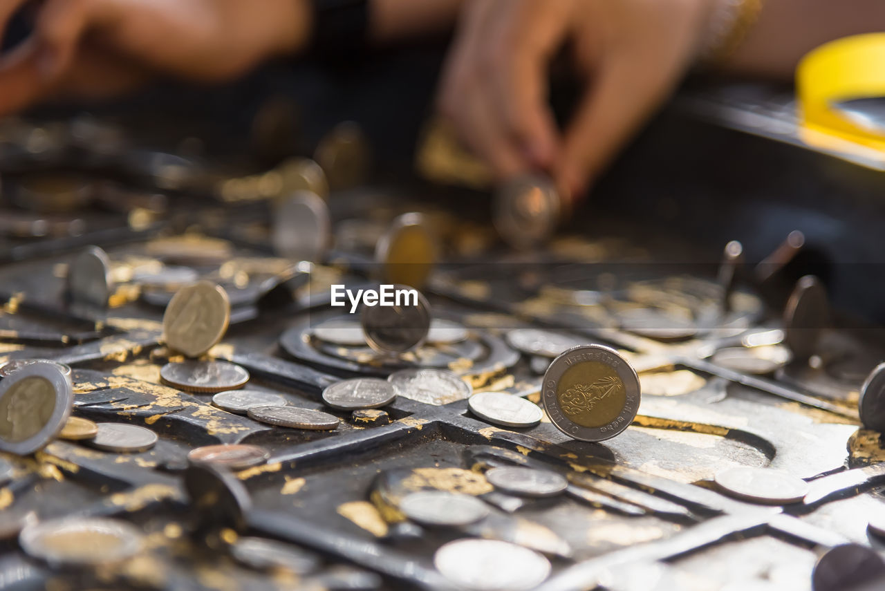 Close-up of hand holding coins