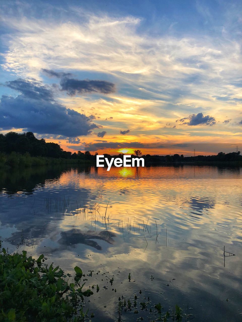 SCENIC VIEW OF LAKE AT SUNSET