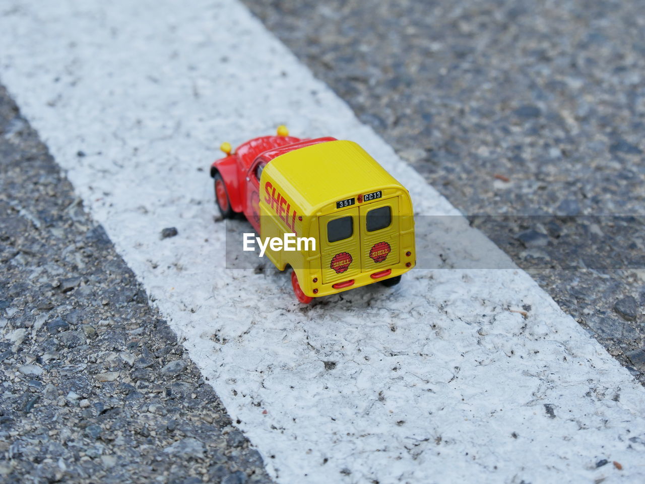 CLOSE-UP OF TOY CAR ON STREET