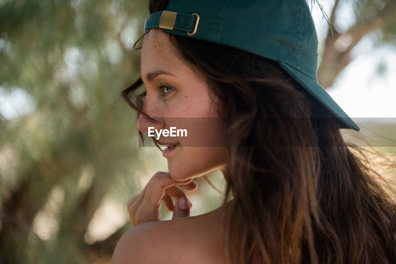 Stylish young woman smiles in the desert