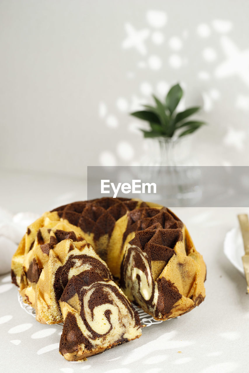 Slice chocolate marble vanilla bundt cake or zebra cake, copy space for text