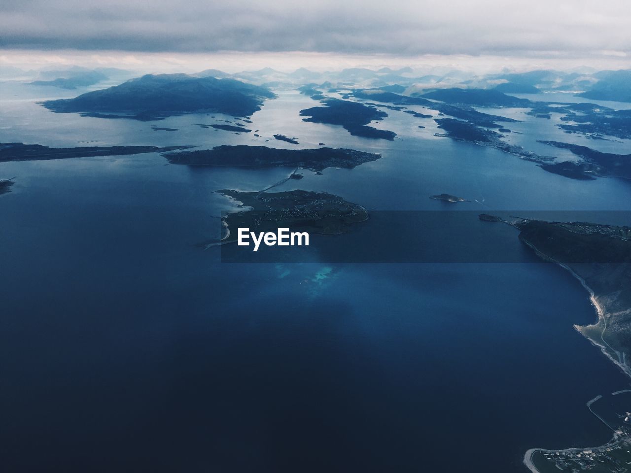 Flying over nordic lands and exploring the coast, aerial view, horizon over the sea and islands 