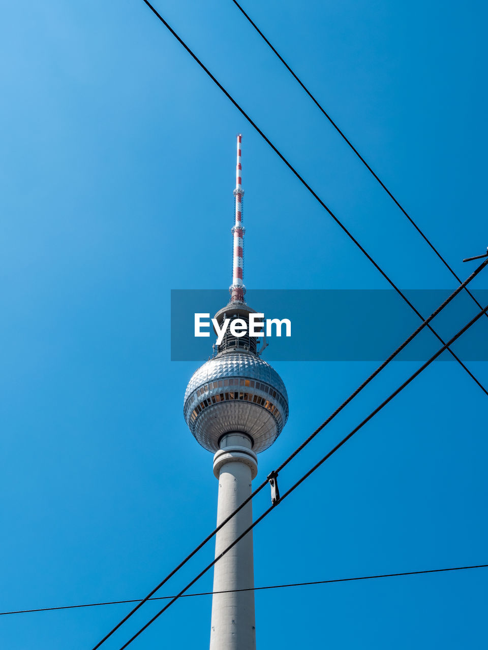 LOW ANGLE VIEW OF COMMUNICATIONS TOWER AGAINST CLEAR BLUE SKY