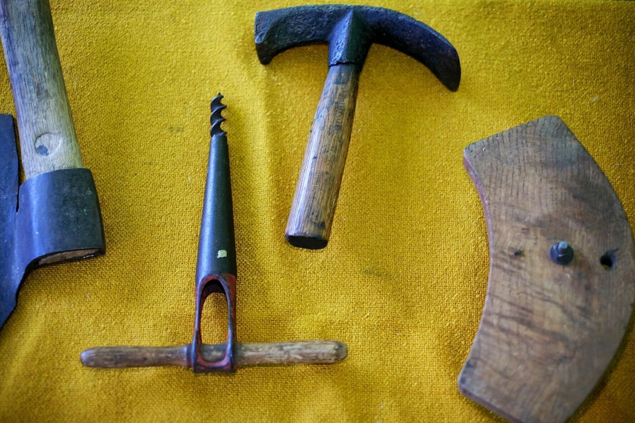 High angle view of various old work tools on table