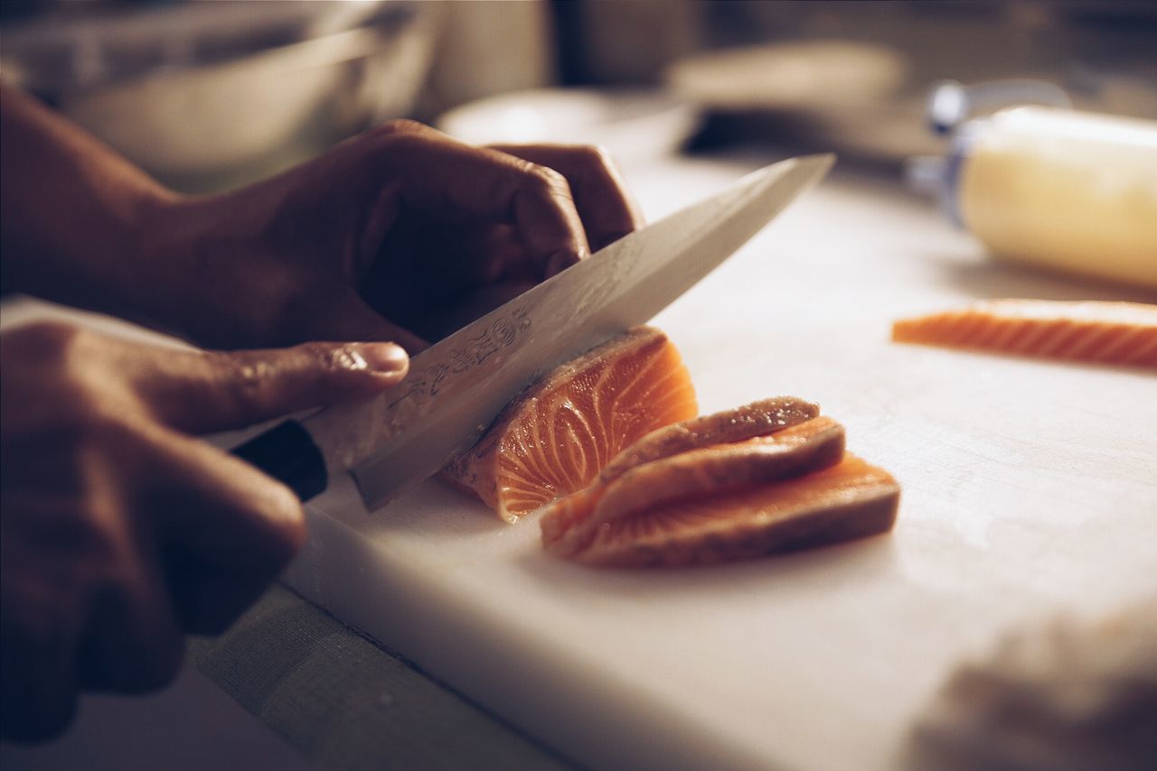 Close-up of person preparing food on table