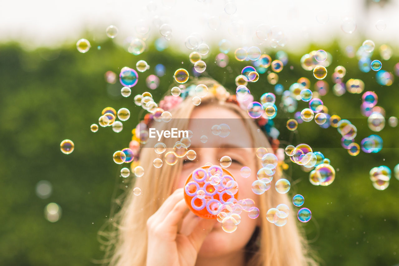 Portrait of beautiful woman with bubbles