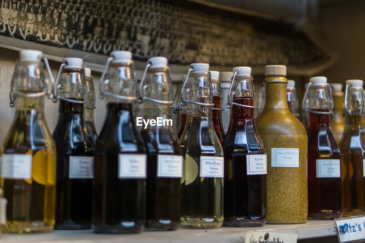 Close-up of drinks in glass bottles on shelf