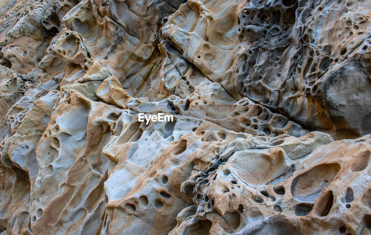 HIGH ANGLE VIEW OF ROCKS ON BEACH