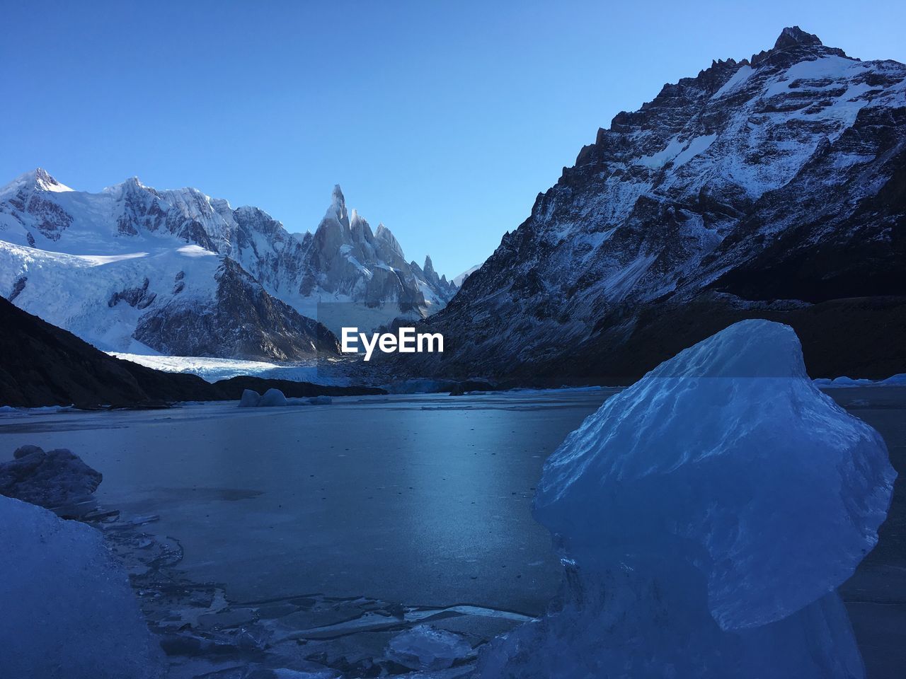 Frozen lake with mountains in background
