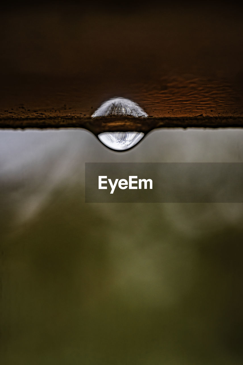 CLOSE-UP OF RAINDROPS ON WATER