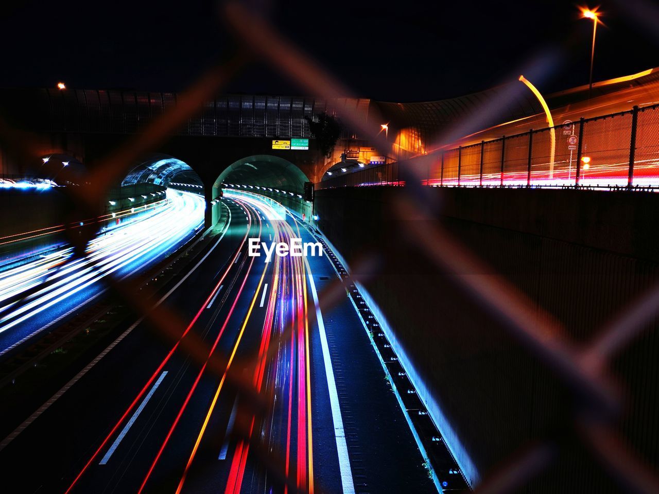 light trail, illuminated, night, long exposure, motion, speed, architecture, transportation, city, blurred motion, light, traffic, built structure, city life, tail light, road, street, mode of transportation, building exterior, no people, lighting equipment, highway, travel destinations, travel, multi colored, bridge, darkness, light - natural phenomenon, on the move, outdoors, street light, cityscape, motor vehicle, headlight, city street, the way forward