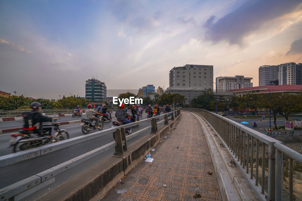 STREET AMIDST BUILDINGS AGAINST SKY