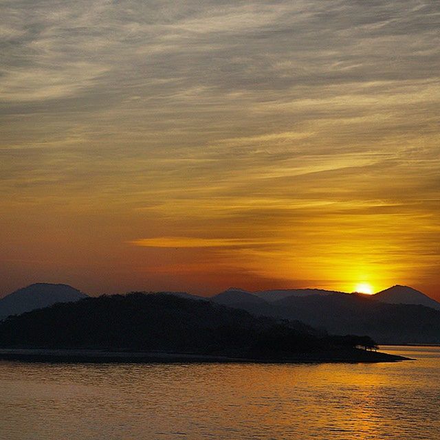 SCENIC VIEW OF SUNSET OVER SEA