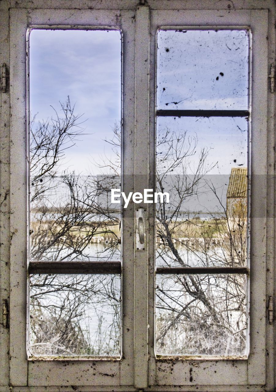 ABANDONED WINDOW AGAINST SKY