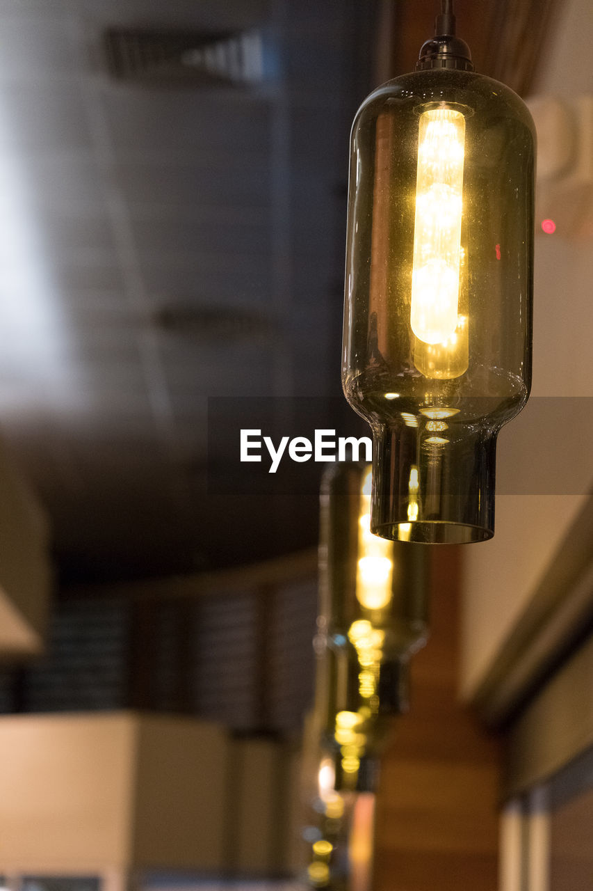 CLOSE-UP OF LIT CANDLES IN THE DARK