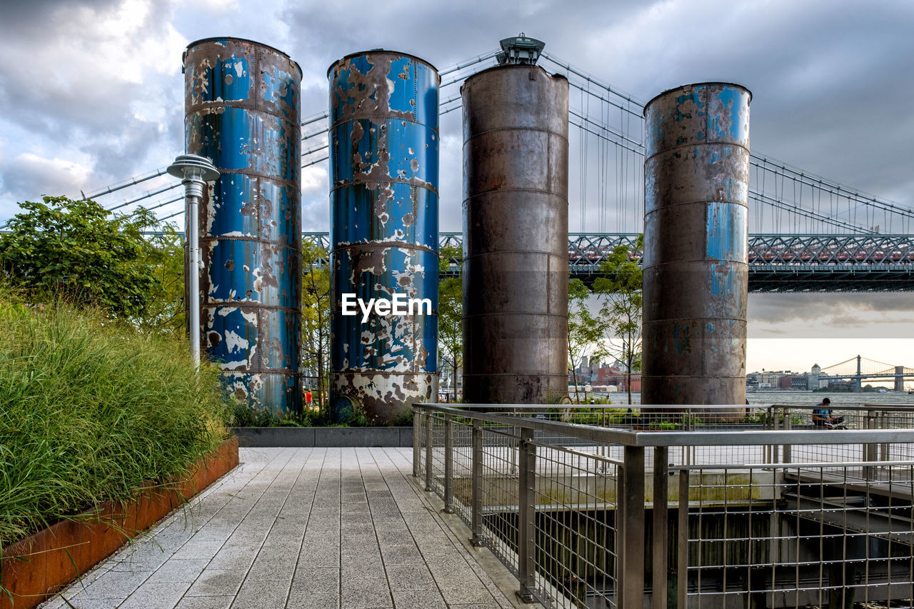 LOW ANGLE VIEW OF FACTORY AGAINST CLOUDY SKY