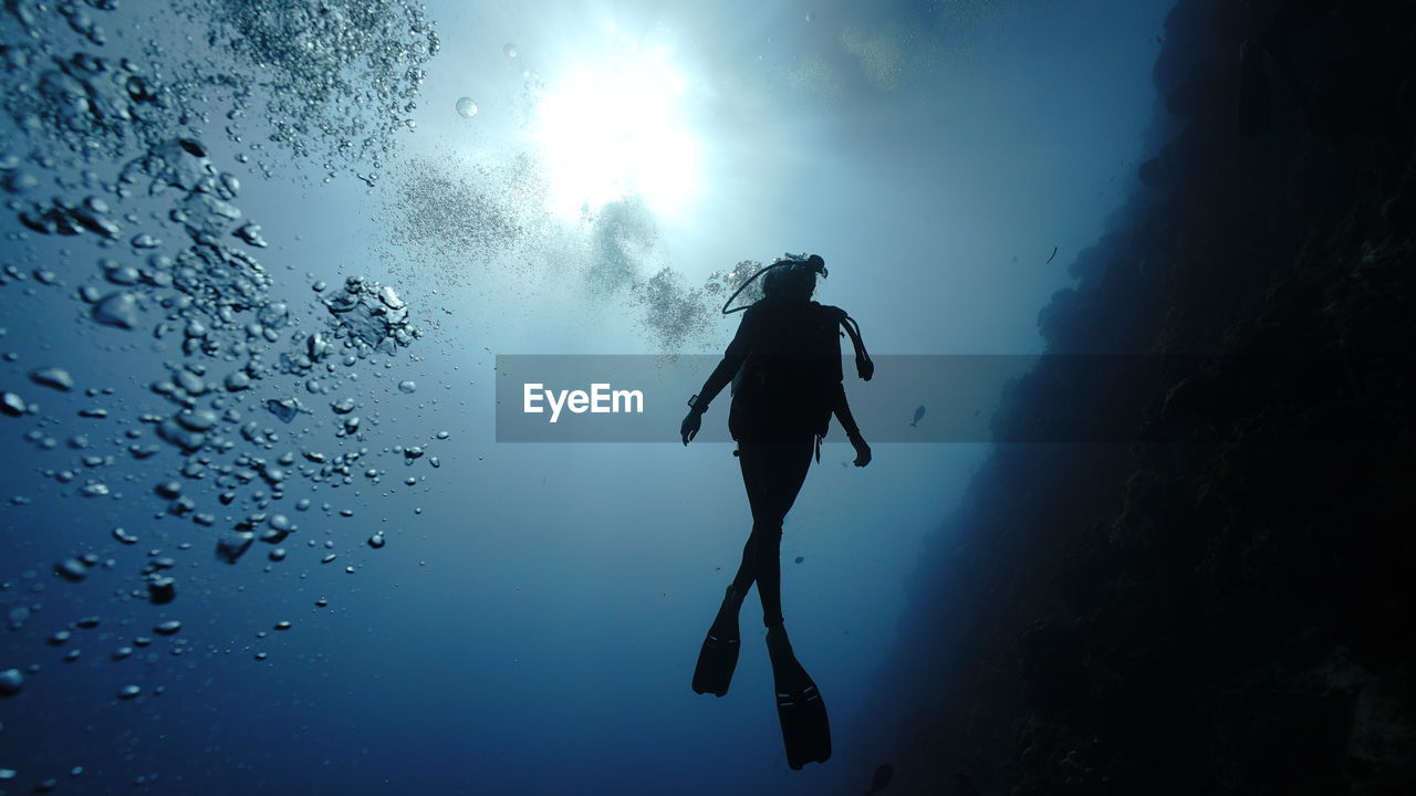 Low angle view of man in sea against sky