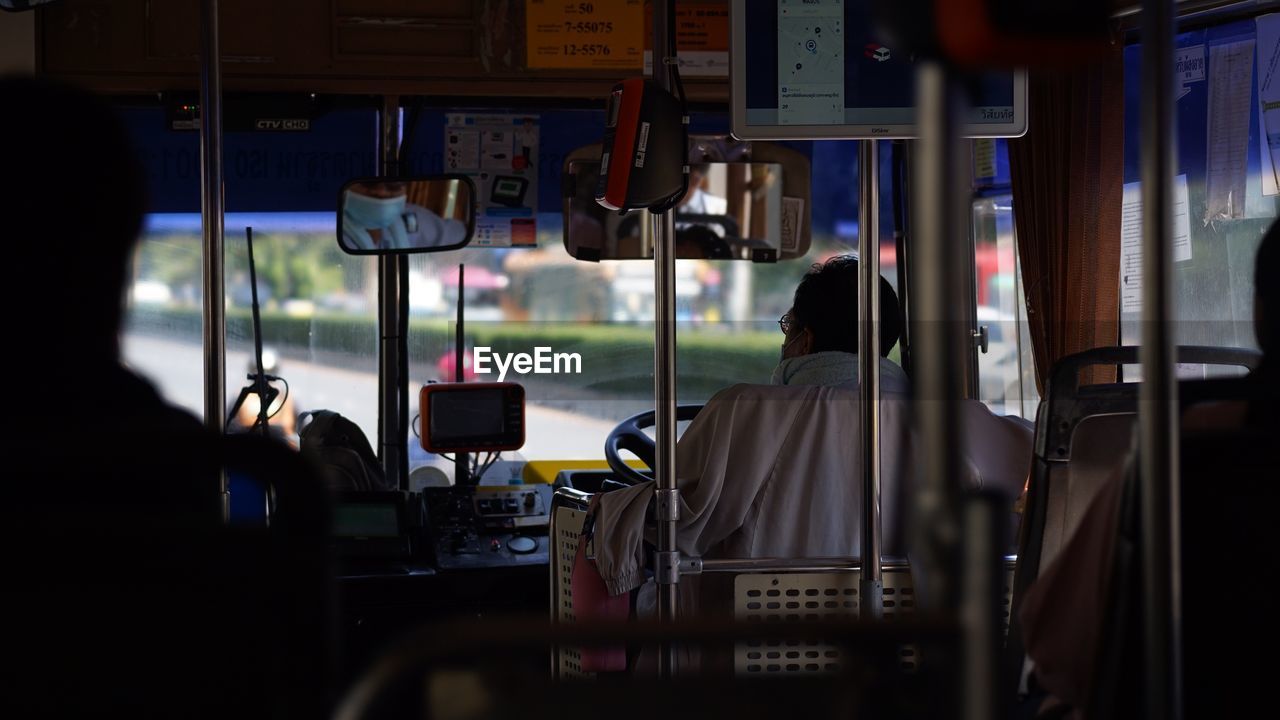 Rear view of driver driving vehicle