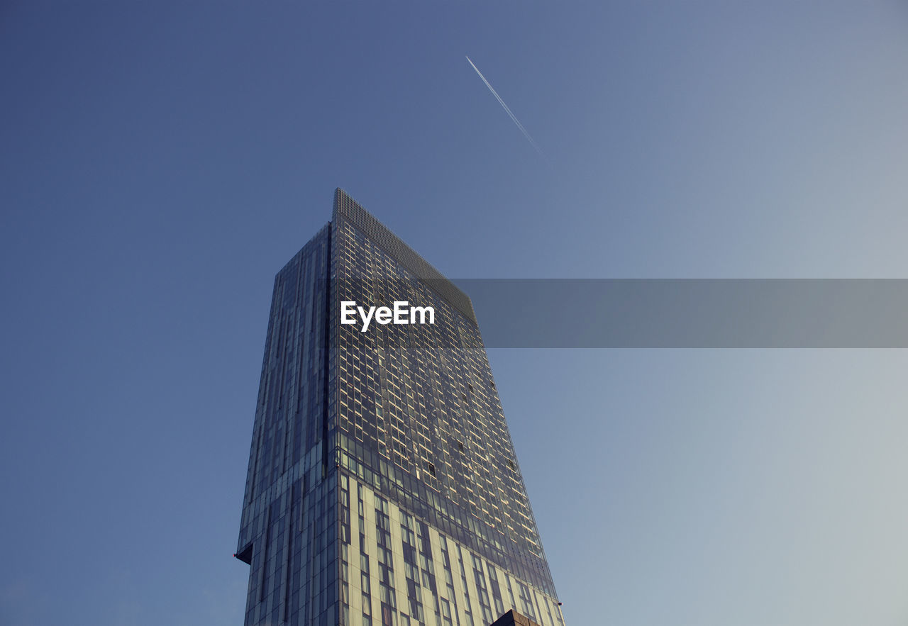 Low angle view of skyscraper against clear sky